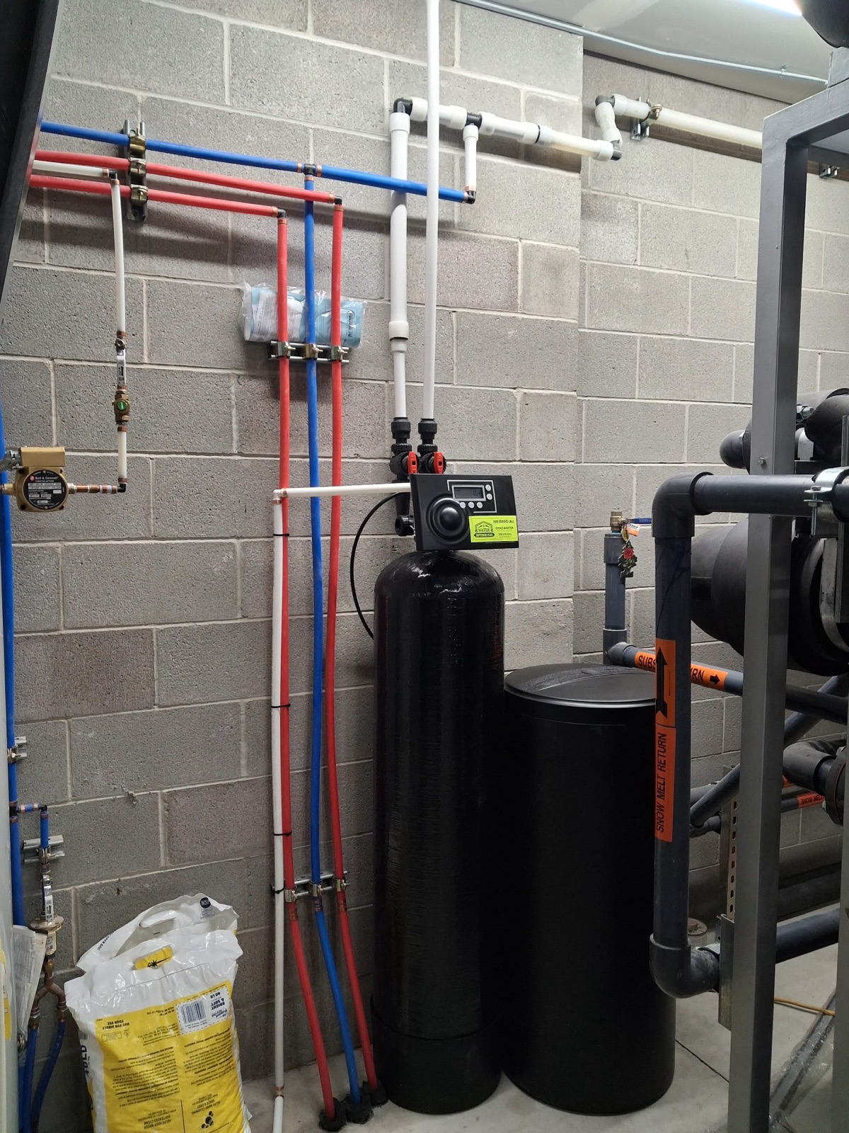 90,000-grain commercial water softener and brine tank installed by Water Softeners Plus in the mechanical room at The Neutral Zone ice rink in Rexburg, Idaho