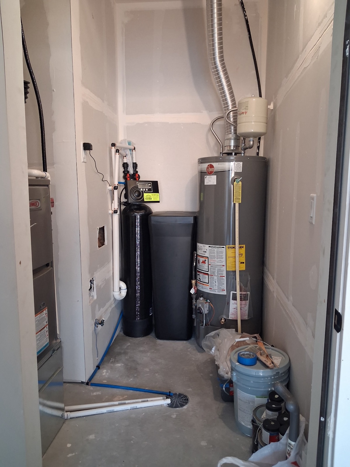 NuGen Fusion XT water softener and brine tank installed by Water Softeners Plus in the utility room of a newly built Southeast Idaho home, next to the new water heater it protects